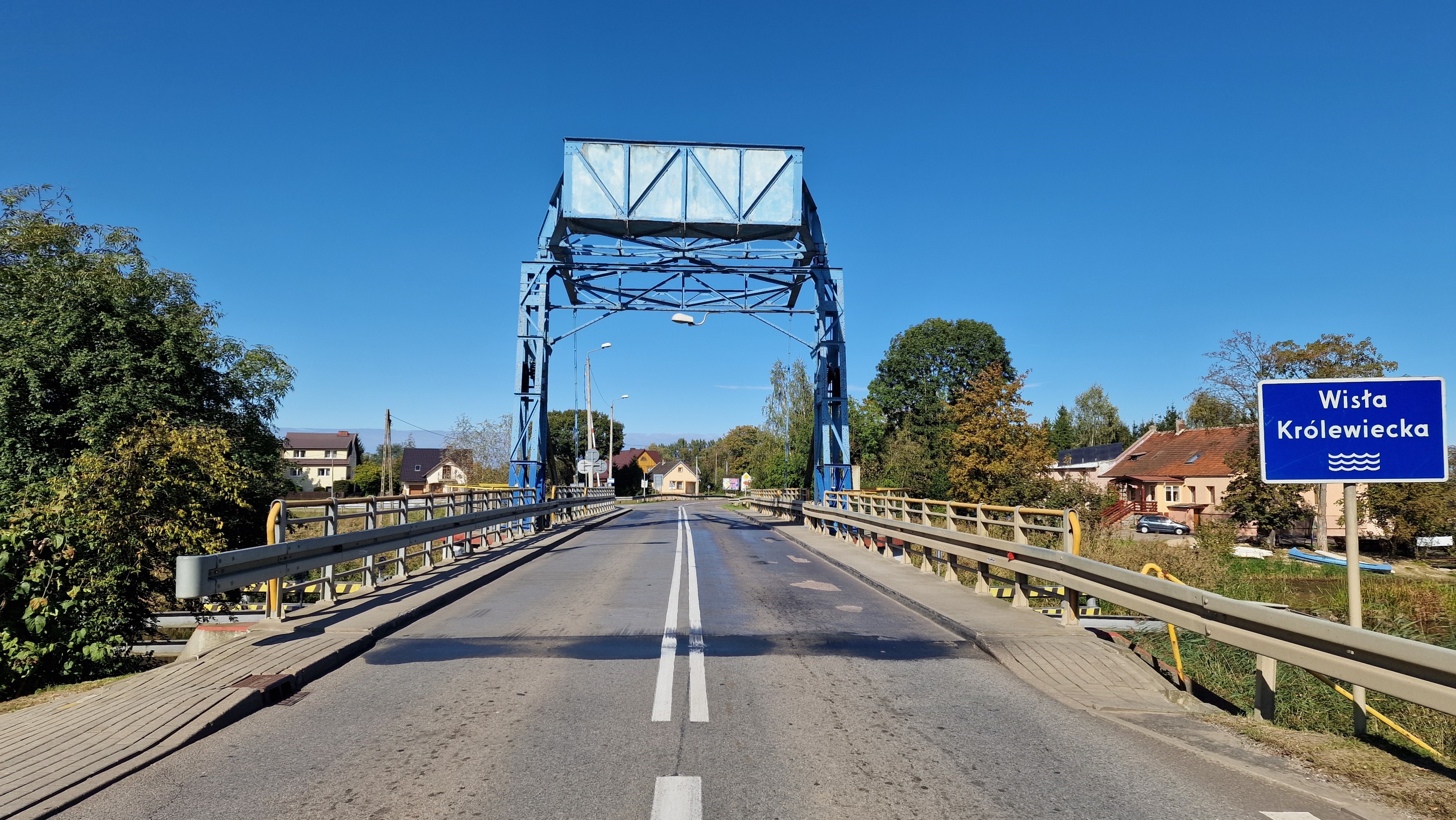 zdjęcie przedstawia most zwodzony przez Wisłę Królewiecką w Rybnie w ciągu drogi wojewódzkiej nr 502, opuszczony dla ruchu samochodowego. Po obu stronach bariery drogowe i po prawej stronie znak informacyjny o Wiśle Królewieckiej.